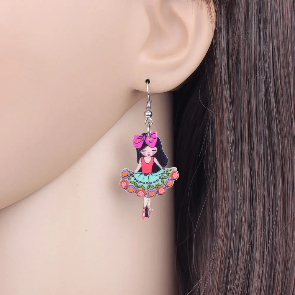 a mannequin wearing a pair of colorful ballerina earrings