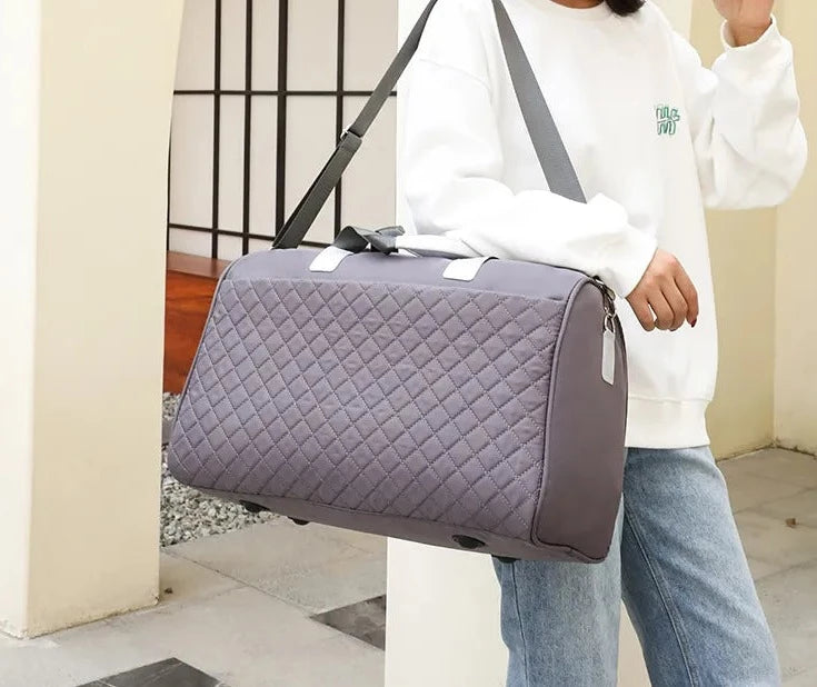 woman carrying gray sports and dance bag