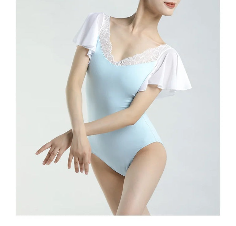 Woman wearing light blue and white butterfly sleeveslace ballet leotard with