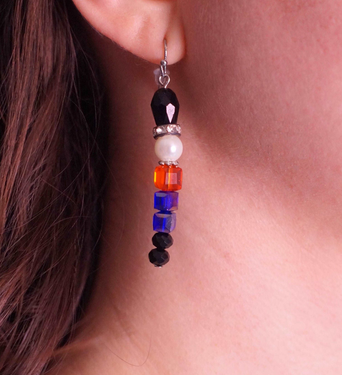 Woman wearing handmade beaded nutcracker earrings