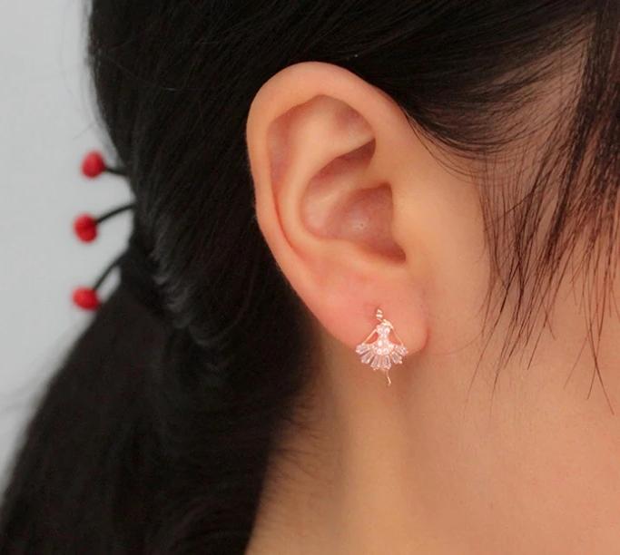 woman wearing rose colored crystal stud ballerina earrings