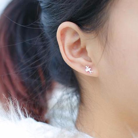 Girl wearing silver stud ballerina earrings
