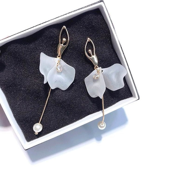Front of gold tone and white ballerina dangle earrings