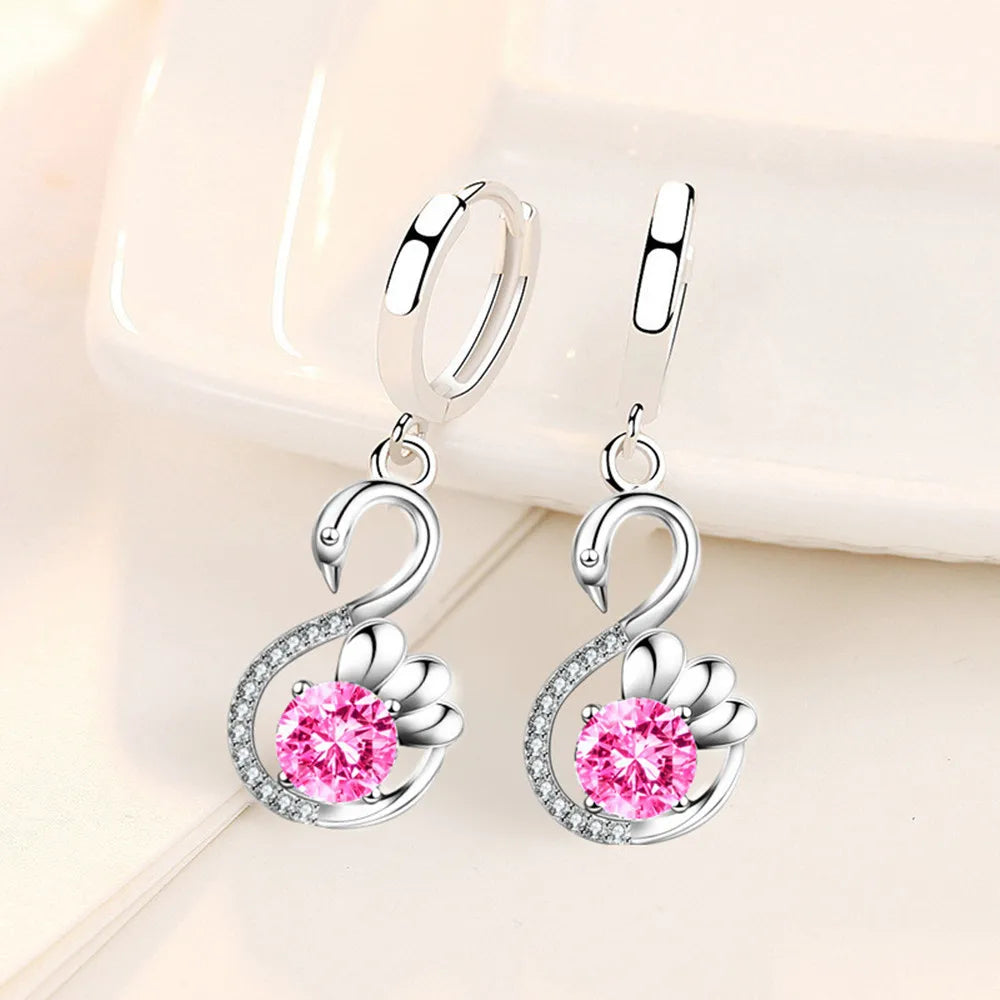 Pair of silver swan earrings with pink cubic zirconia