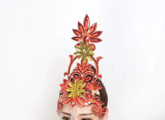 front of woman wearing a red sequined ballet headpiece