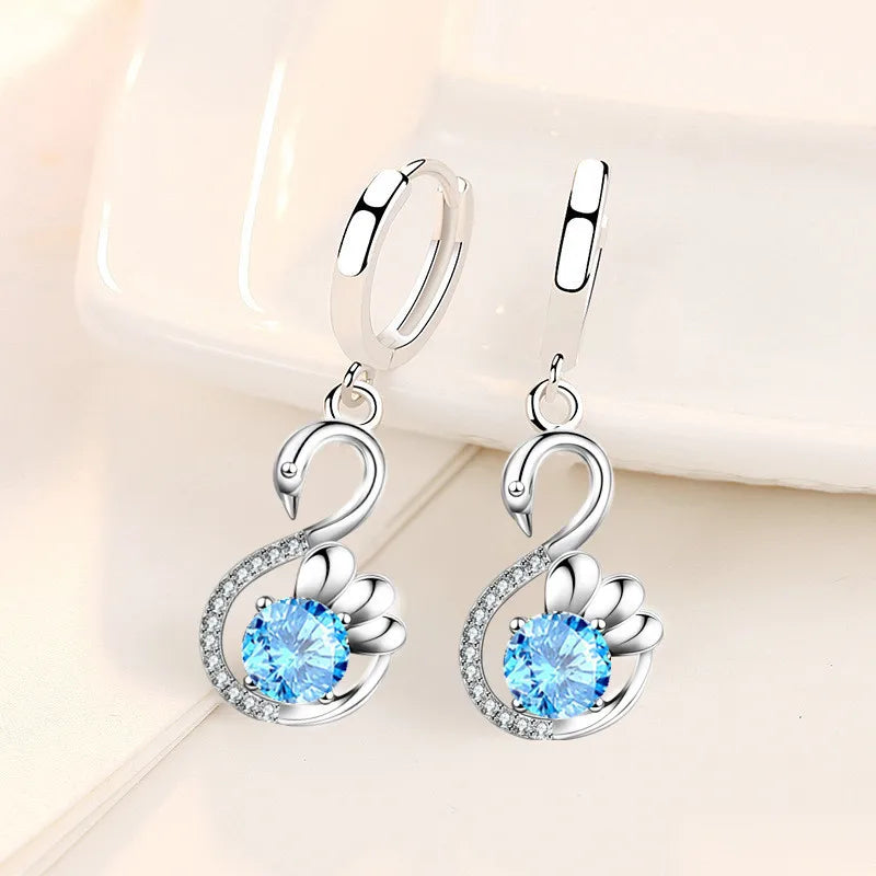 Pair of silver swan earrings with blue cubic zirconia