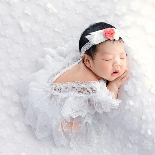 newborn wearing white lace tutu dress with matching headband