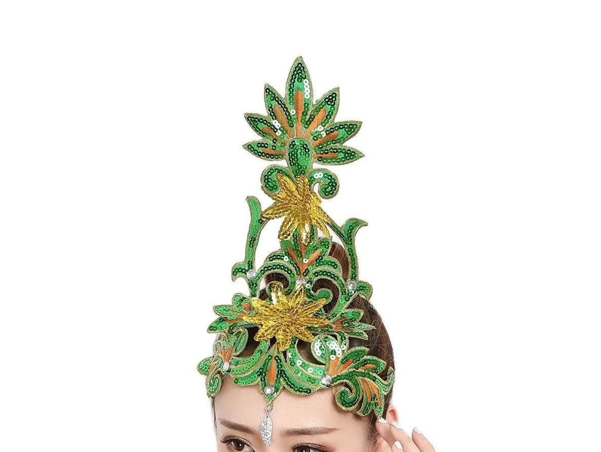 front of woman wearing a green sequined ballet headpiece