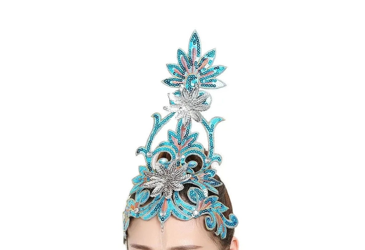 front of woman wearing a turquoise sequined ballet headpiece