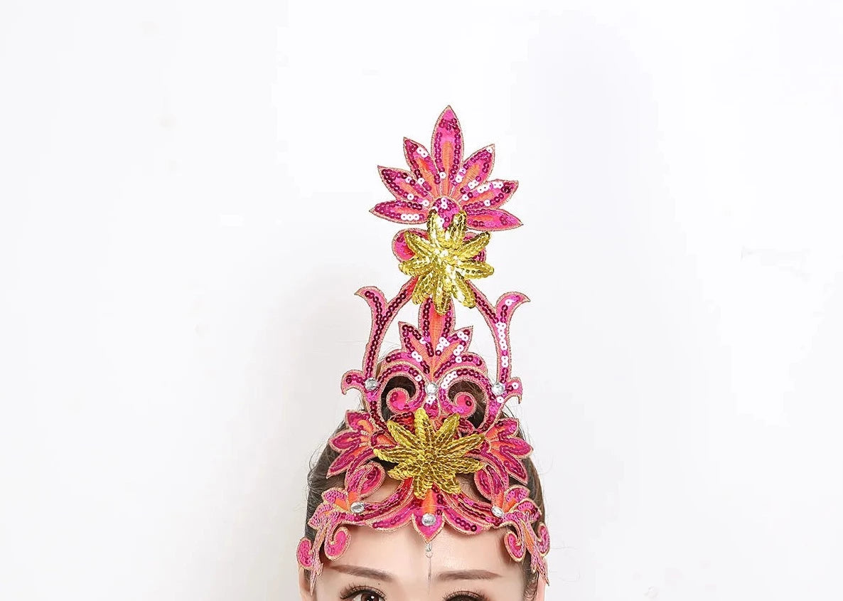 front of woman wearing a pink sequined ballet headpiece
