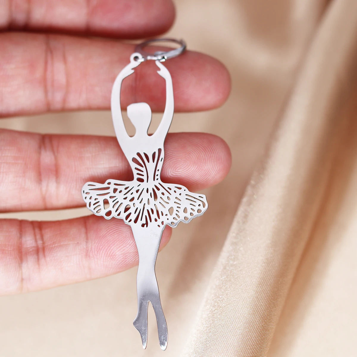 a pair of stainless steel ballerina earrings