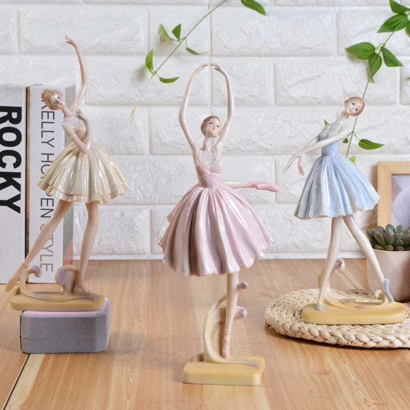 Three ballet dancer figurines in beige blue and pink
