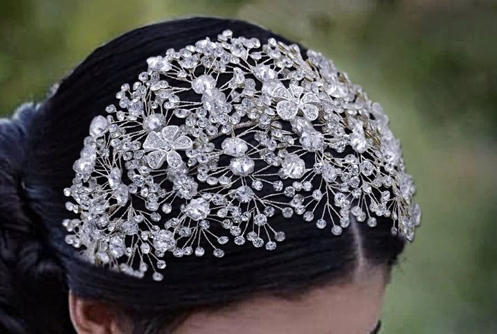 woman wearing a crystal bridal and ballerina headpiece with crystal flowers