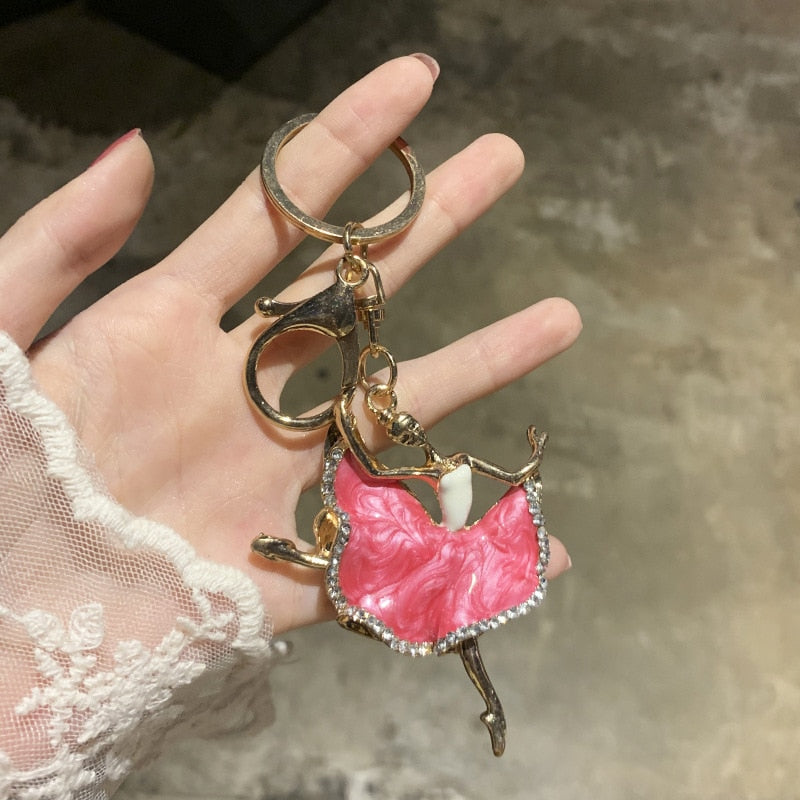 woman holding ballerina key chain
