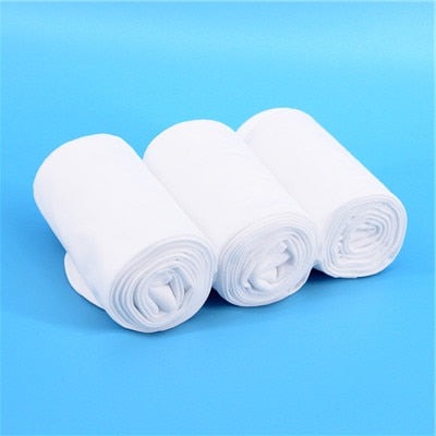 three pairs of rolled white ballet tights