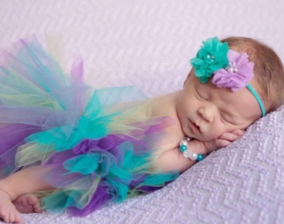 baby wearing blue and purple tutu
