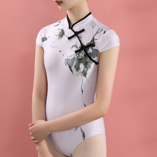 front of woman wearing white and floral mandarin collar leotard