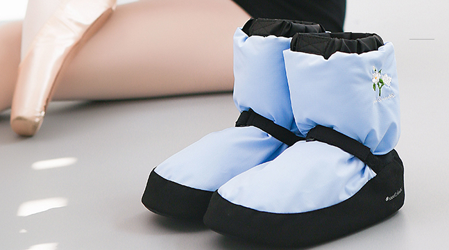 front of light blue ballet warm up booties with embroidered flower